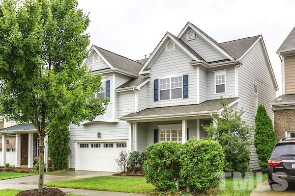 1144 Chapanoke Road Raleigh, NC 27603 - Photo 1 of 22 a view of a white house next to a yard with plants and trees
