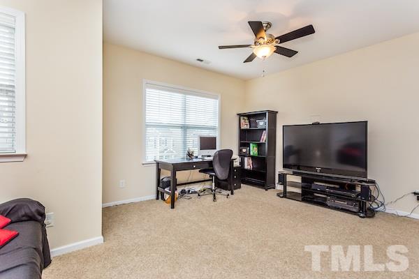 1144 Chapanoke Road Raleigh, NC 27603 - Photo 11 of 22 a living room with furniture and a flat screen tv