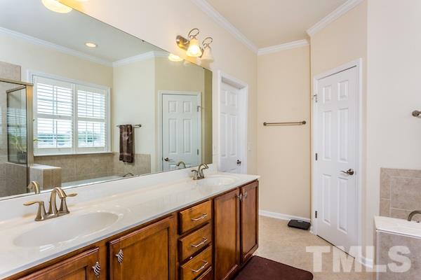 1144 Chapanoke Road Raleigh, NC 27603 - Photo 13 of 22 a bathroom with a sink double vanity and a mirror