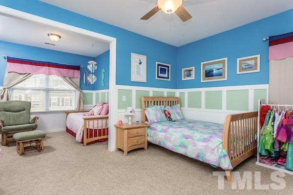 1144 Chapanoke Road Raleigh, NC 27603 - Photo 15 of 22 a bedroom with two beds and a chandelier