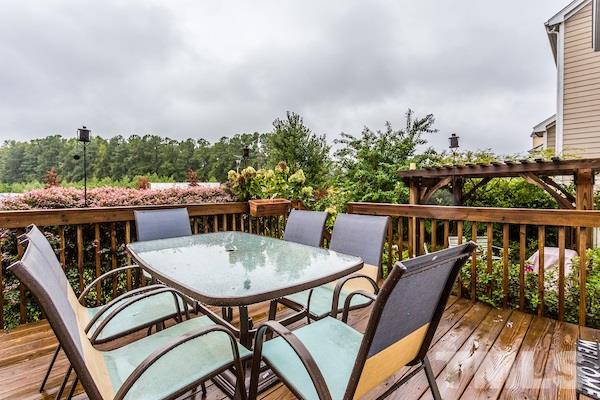 1144 Chapanoke Road Raleigh, NC 27603 - Photo 19 of 22 a balcony with wooden floor outdoor seating and city view