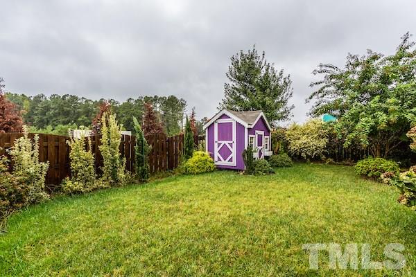 1144 Chapanoke Road Raleigh, NC 27603 - Photo 22 of 22 a sign that is sitting in the grass with tress in front of it