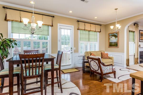 1144 Chapanoke Road Raleigh, NC 27603 - Photo 10 of 22 a dining room with furniture a chandelier and wooden floor