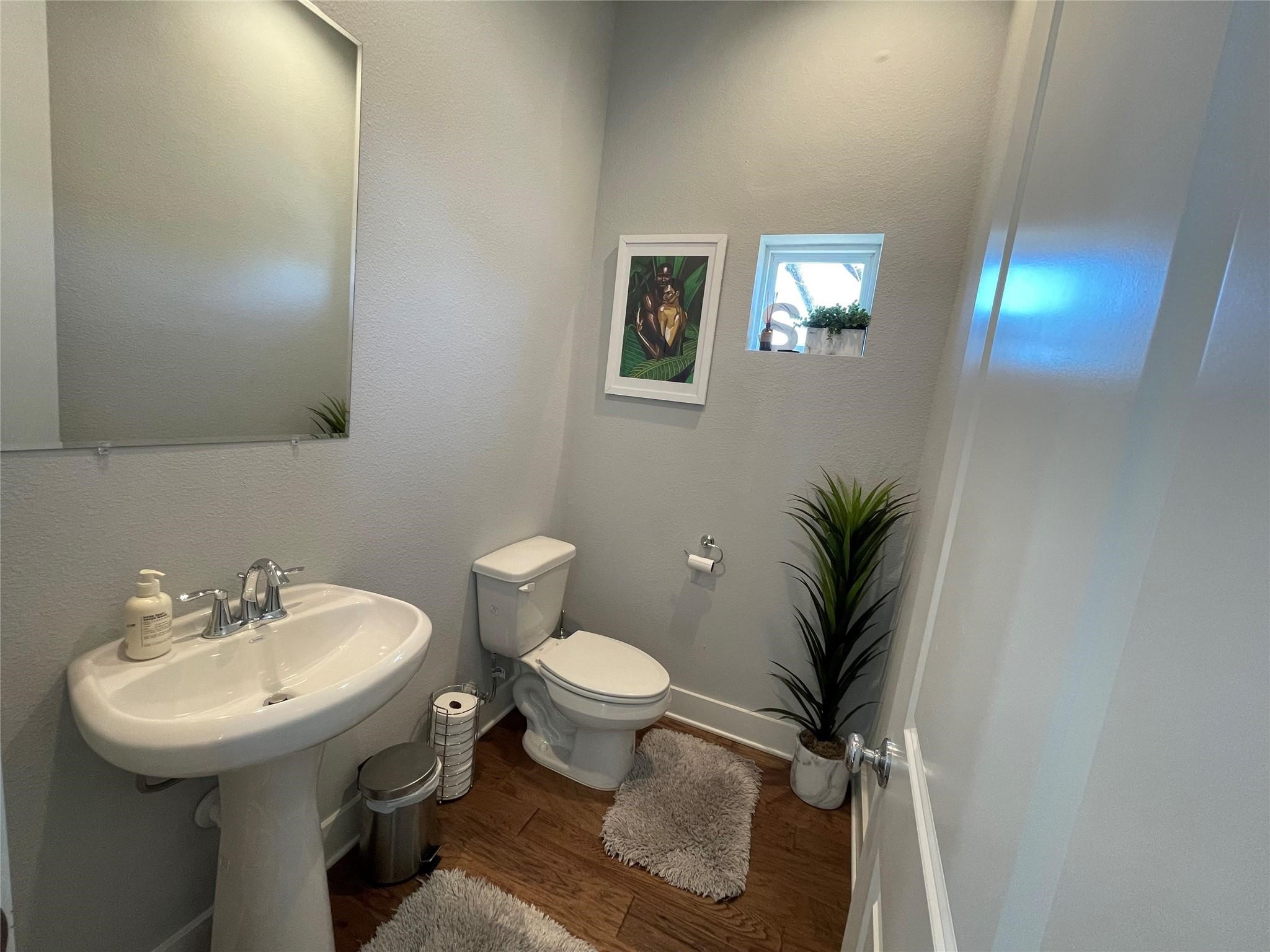 902 Martin Street, Unit A Houston, TX 77018 - Photo 11 of 21 a bathroom with a sink toilet and a mirror