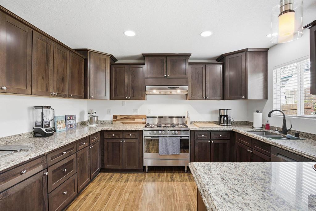1736 San Pasqual Valley Road Escondido, CA 92027 - Photo 2 of 34 a kitchen with stainless steel appliances granite countertop a sink stove and refrigerator