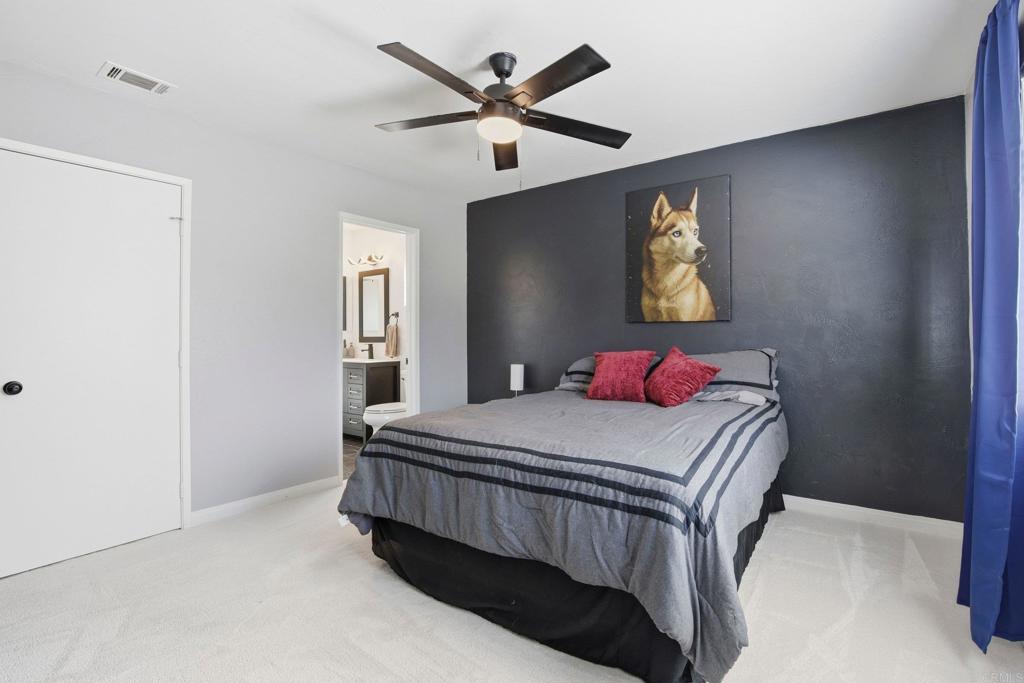 1736 San Pasqual Valley Road Escondido, CA 92027 - Photo 21 of 34 a bedroom with a bed and painting on the wall