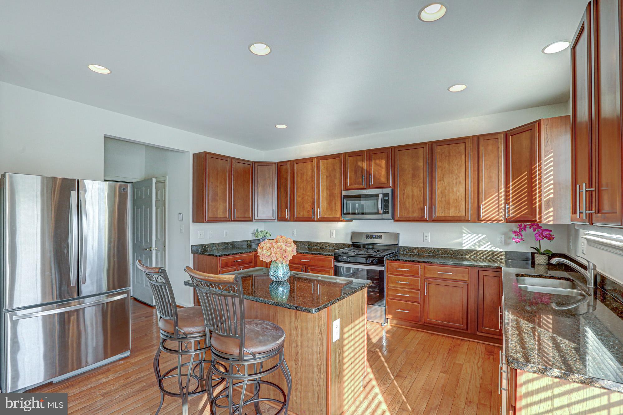 43 Autumn Terrace Magnolia, DE 19962 - Photo 46 of 86 a kitchen with stainless steel appliances granite countertop a refrigerator sink and cabinets
