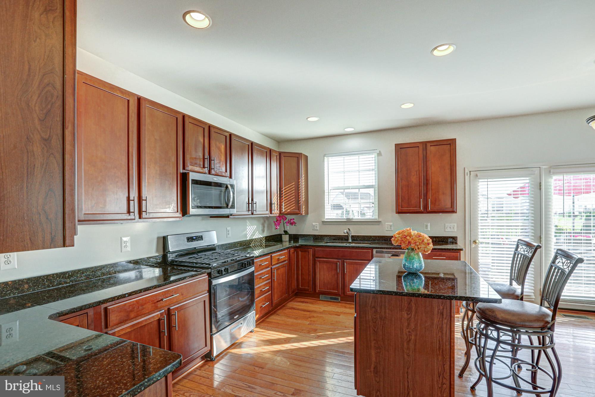 43 Autumn Terrace Magnolia, DE 19962 - Photo 47 of 86 a kitchen with stainless steel appliances granite countertop sink stove top oven and cabinets
