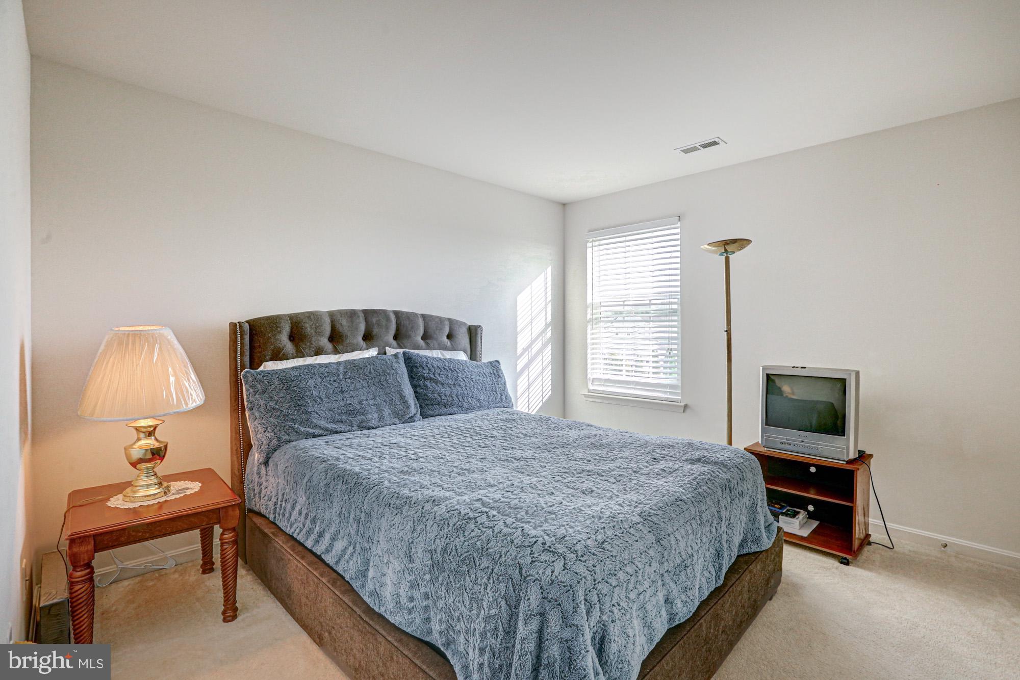 43 Autumn Terrace Magnolia, DE 19962 - Photo 58 of 86 a bedroom with a bed and a lamp on table
