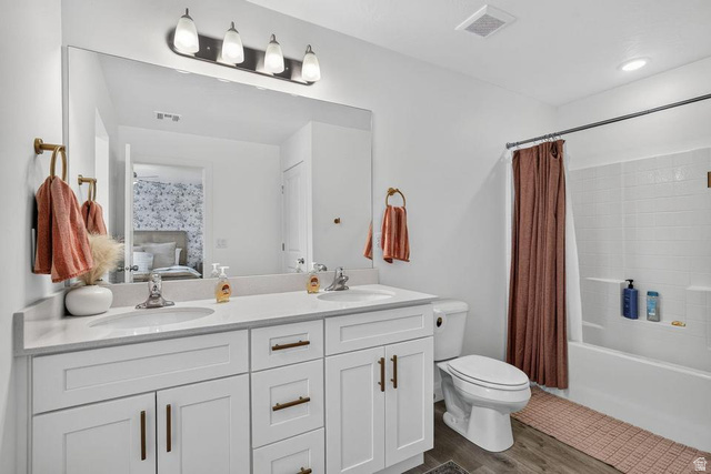 5898 Jasper Rdg Drive St. George, UT 84790 - Photo 20 of 41 Spa-inspired primary bathroom showcasing a dual-sink vanity with white cabinetry, brushed metal hardware, and a quartz countertop