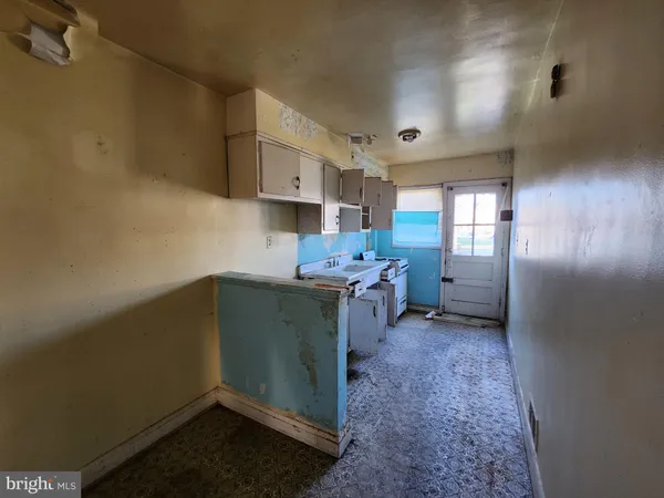 a kitchen with refrigerator and cabinets