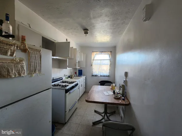 a kitchen with a stove and a refrigerator