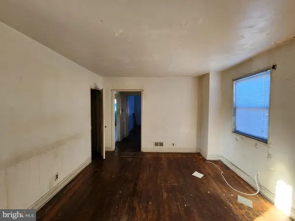 a view of room with window and wooden floor