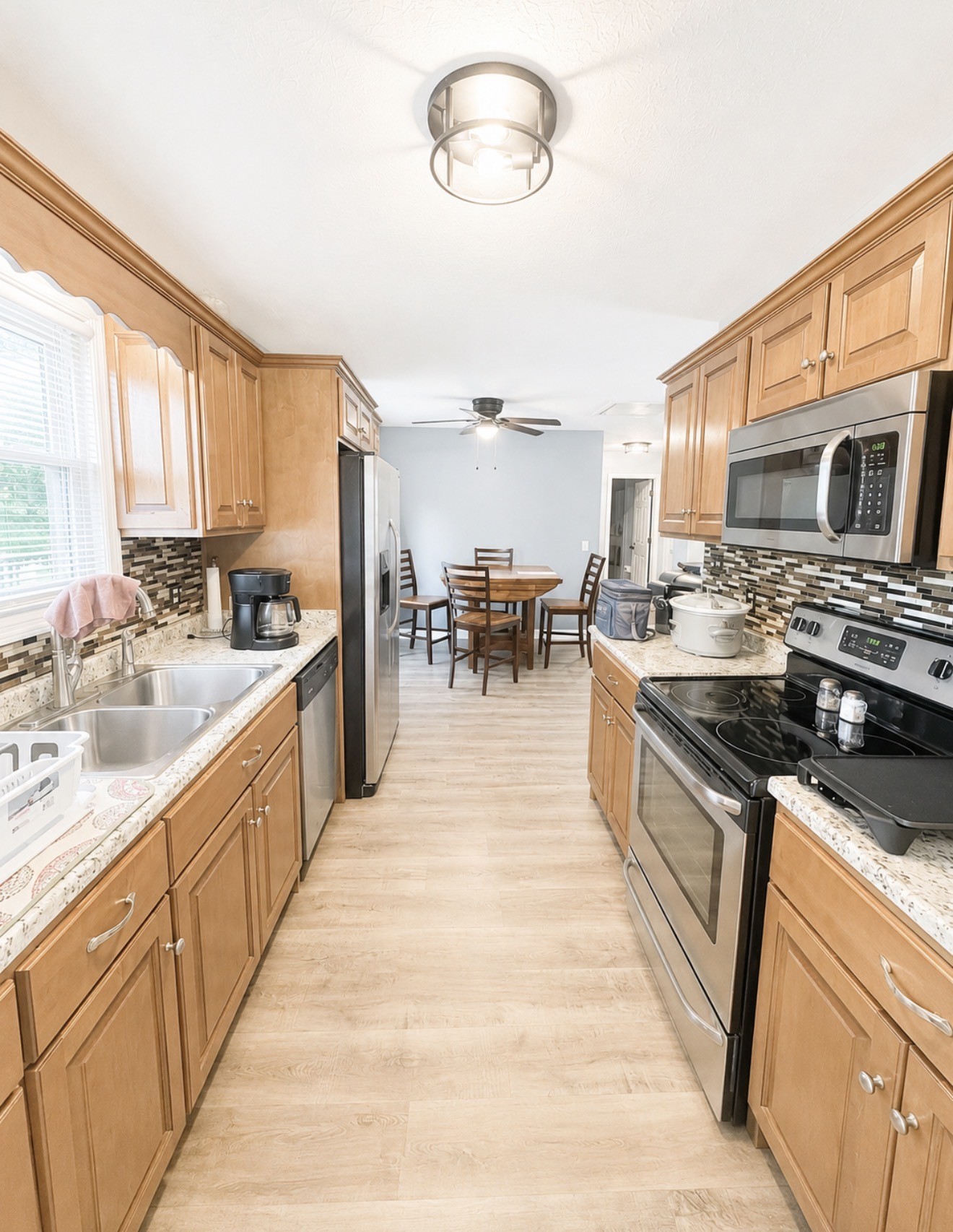 153 Henry Harris Road Westmoreland, TN 37186 - Photo 7 of 18 a large kitchen with stainless steel appliances kitchen island granite countertop a large counter top a stove a sink a dining table and chairs
