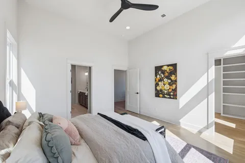 a bedroom with a bed and a painting on the wall