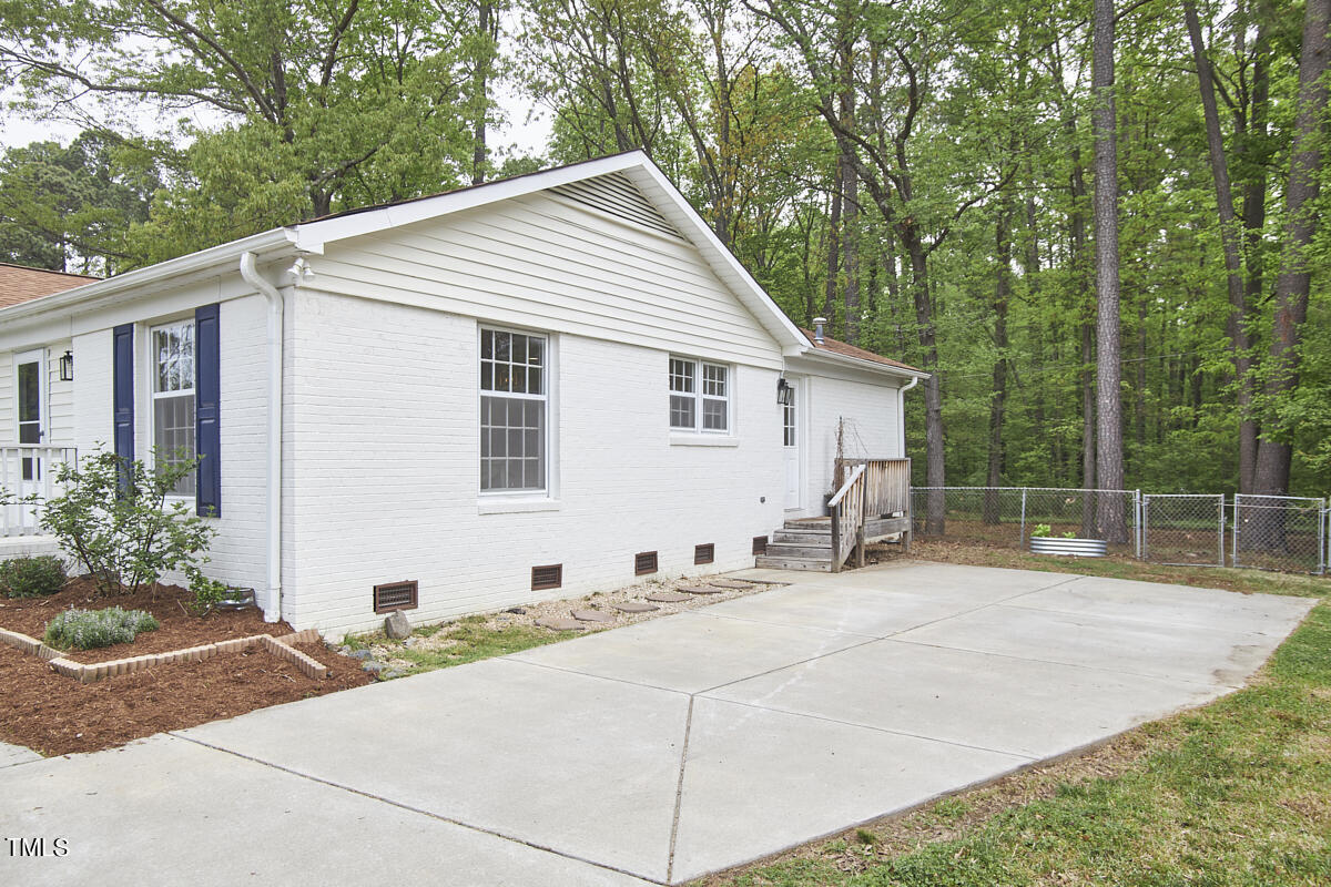 5419 Revere Road Durham, NC 27713 - Photo 44 of 52 a view of a house with backyard and garden