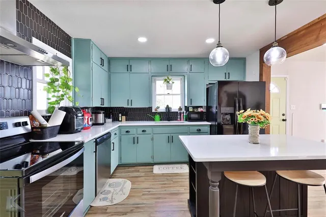 a kitchen with a table and chairs in it