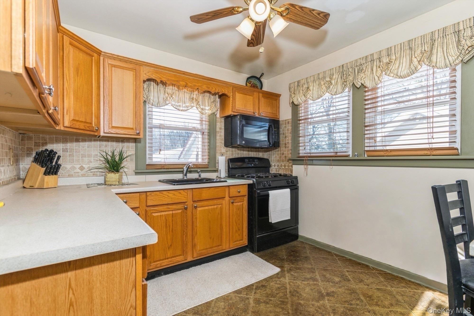 59 Prairie Avenue Suffern, NY 10901 - Photo 7 of 21 a kitchen with stainless steel appliances granite countertop a sink a stove a refrigerator cabinets and a dining table