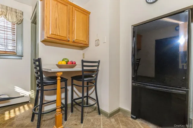 a dining room with furniture and a window