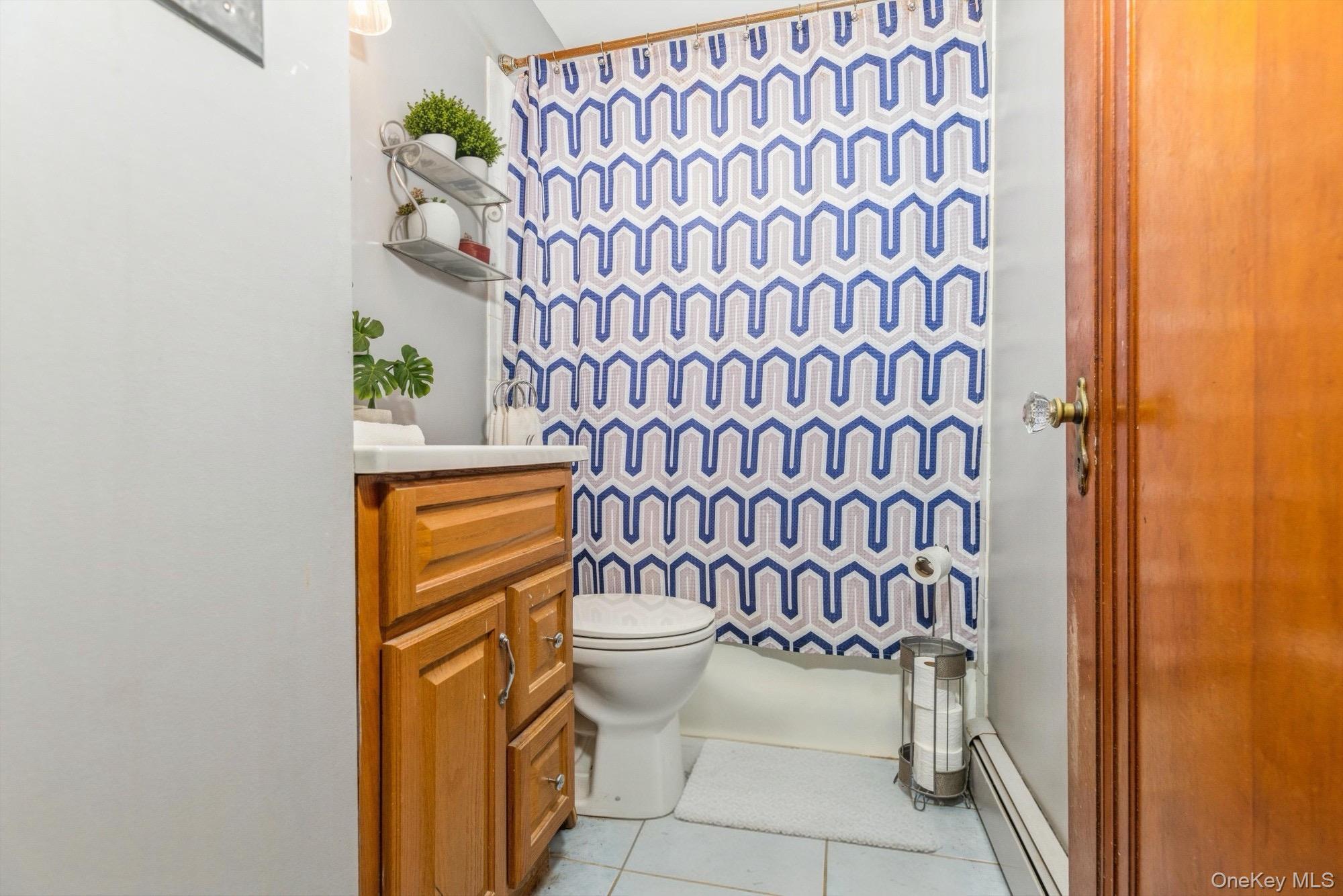 59 Prairie Avenue Suffern, NY 10901 - Photo 10 of 21 a bathroom with a toilet and a shower curtain
