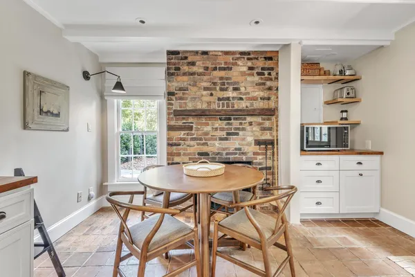 a view of a dining room with furniture and a window
