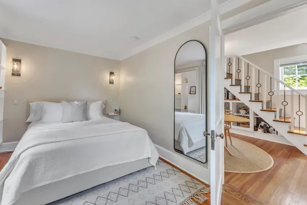 a bedroom with a bed and a mirror