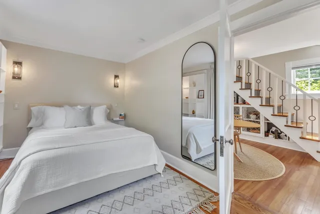 a bedroom with a bed and a mirror