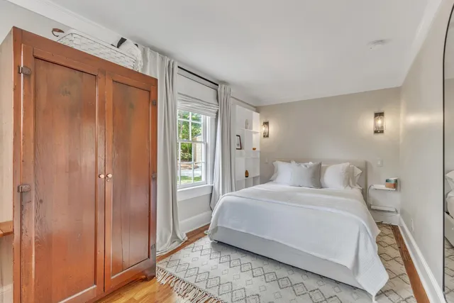 a bedroom with a bed and a mirror