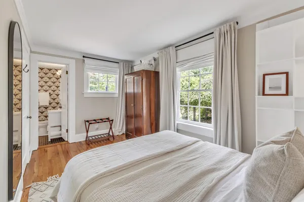 a bedroom with a bed and a large window