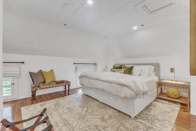 a bedroom with a bed and chair