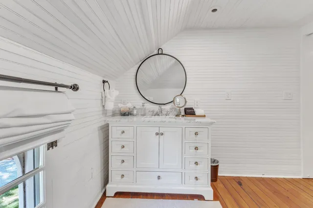 a bathroom with a sink vanity and mirror