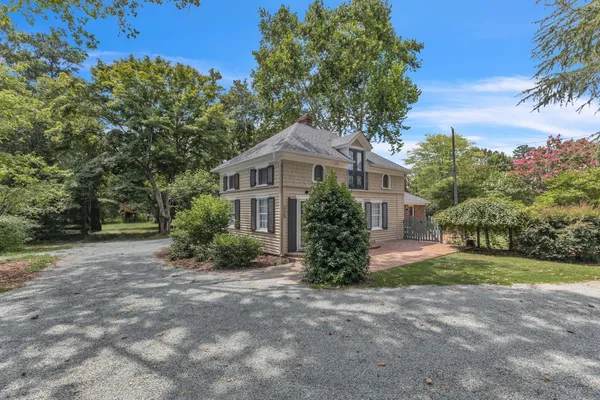 a front view of a house with a garden