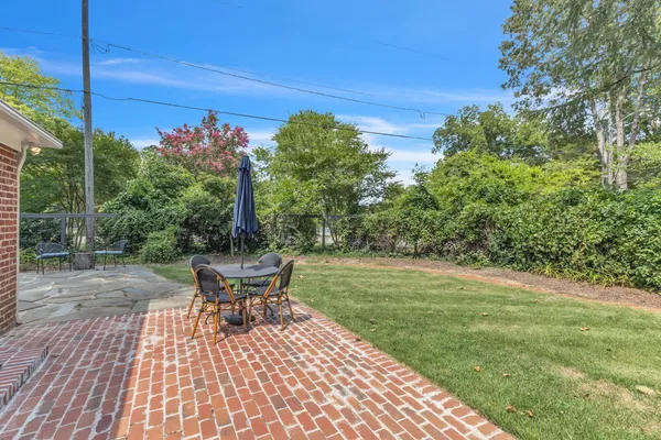 a view of a backyard with sitting area