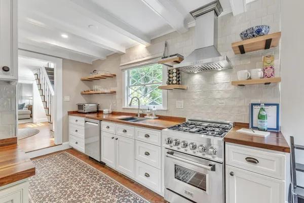 a kitchen with stainless steel appliances a stove a sink and a refrigerator