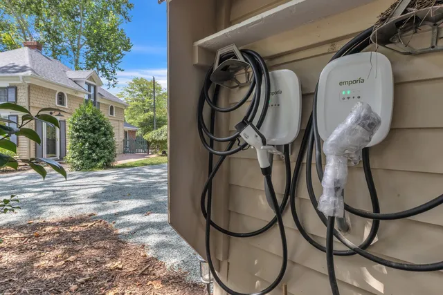 a view of a house with a yard and large tree
