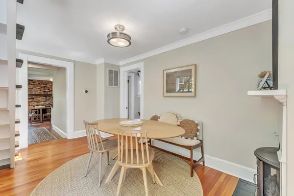 a dining room with furniture and wooden floor
