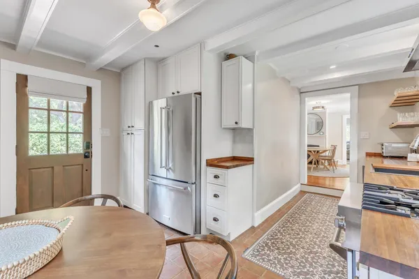 a kitchen with stainless steel appliances granite countertop a refrigerator and a stove top oven