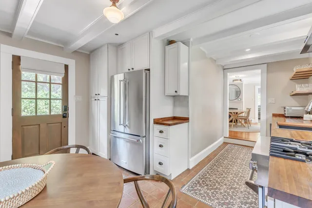a kitchen with stainless steel appliances granite countertop a refrigerator and a stove top oven