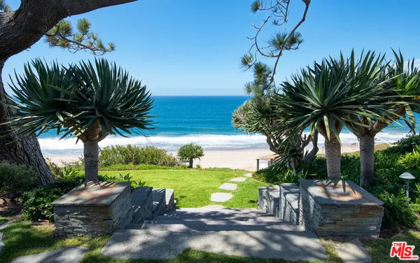 a view of a yard with an ocean view