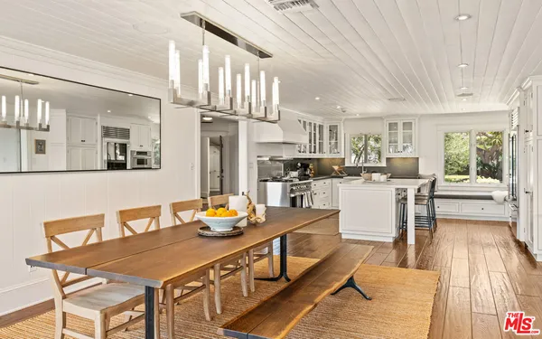 a kitchen with a sink a stove and a wooden floor