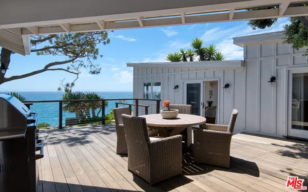 a bedroom with a bed and a large window with outer view