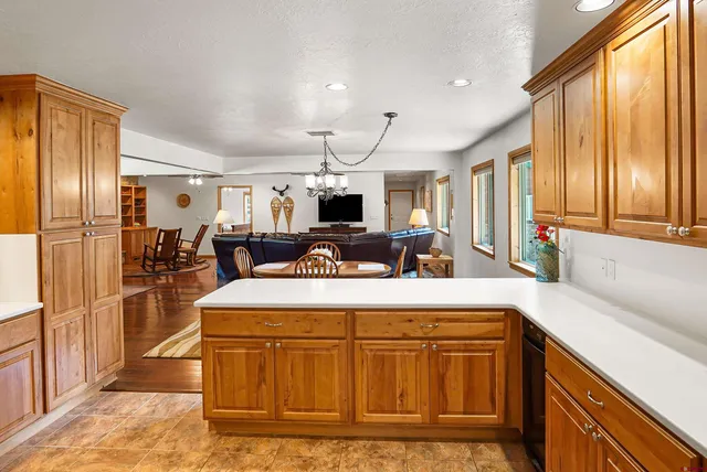 a kitchen with kitchen island a counter space and a refrigerator