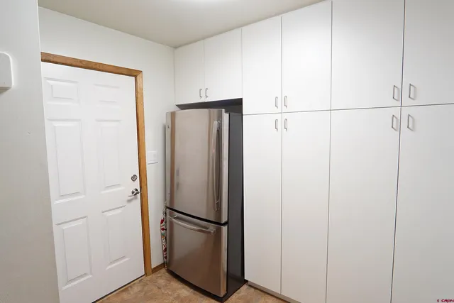 a bedroom with a bed a window and a chandelier