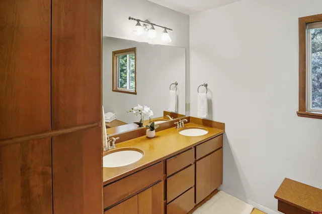 a bathroom with a double vanity sink and a mirror