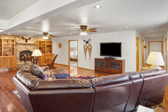 a living room with furniture and wooden floor