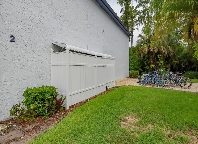 a view of a backyard with potted plants and a large tree