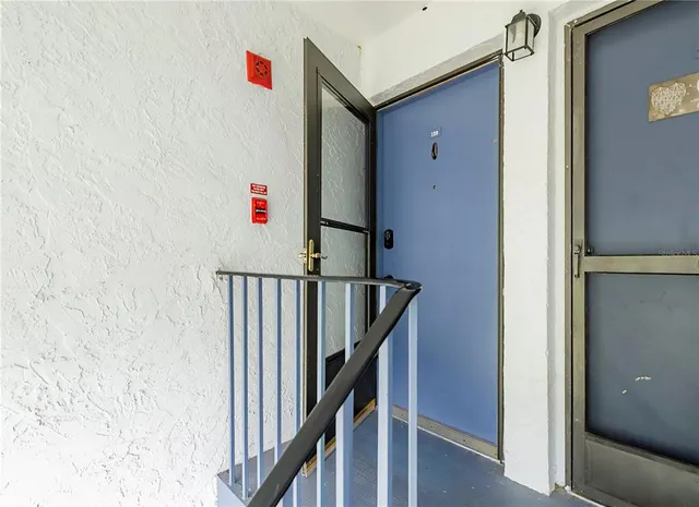 a utility room with wooden floor and entryway