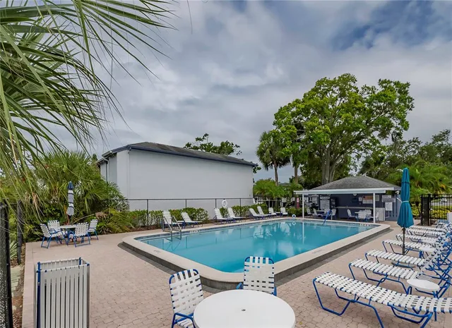 a view of a house with swimming pool and sitting area