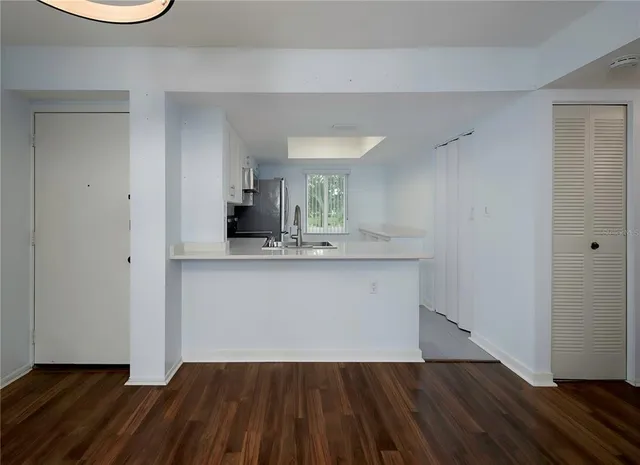 a view of a kitchen cabinets and wooden floor