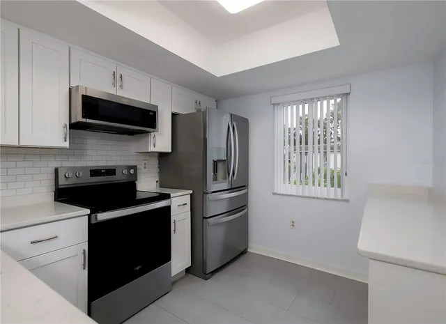 a kitchen with stainless steel appliances a stove microwave and a refrigerator